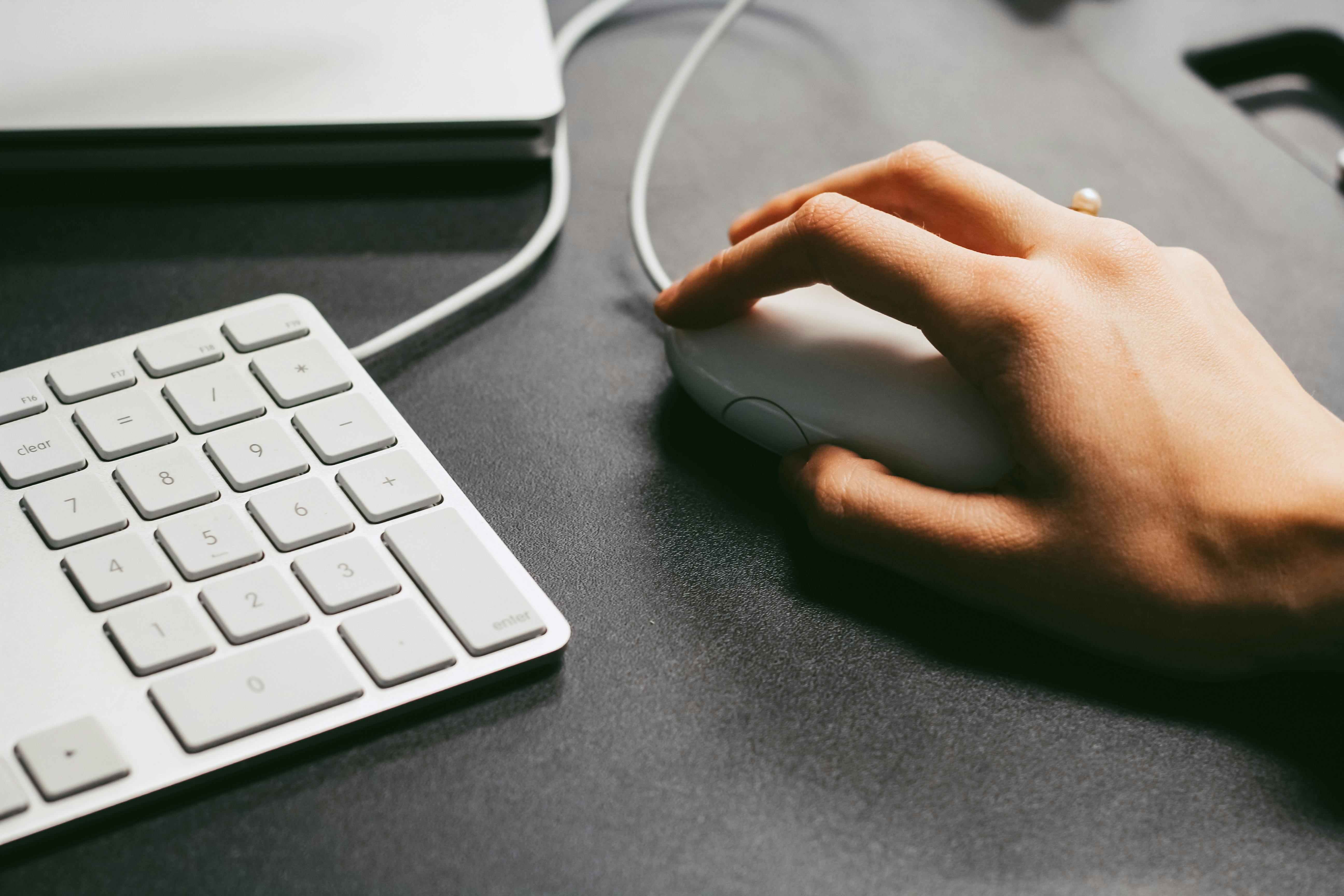 Person clicking computer mouse
