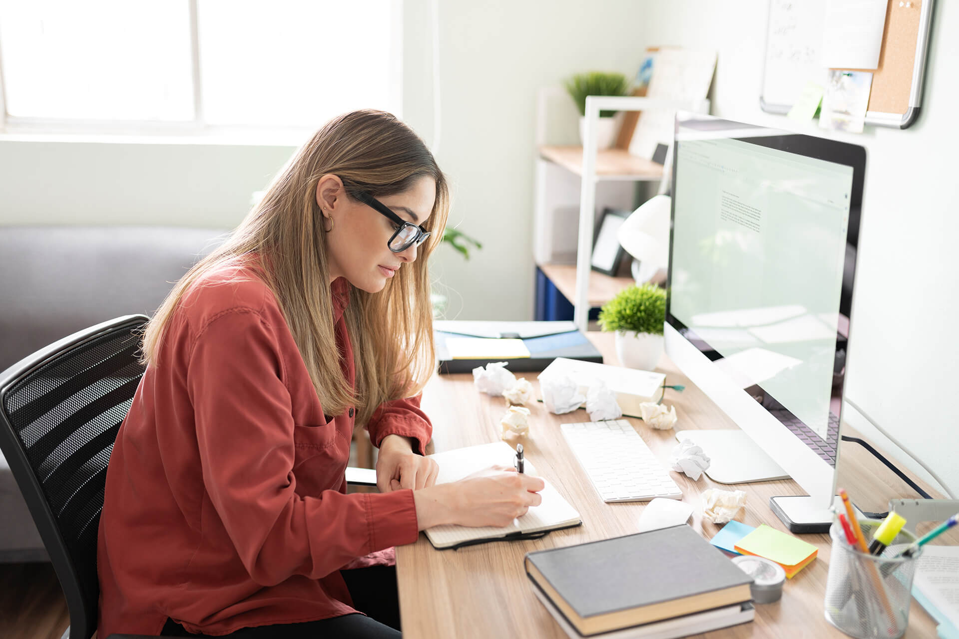 A copywriter sat at a desk writing